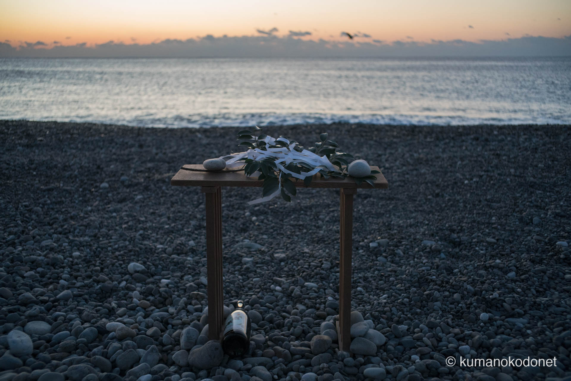 波打ち際にお供えされた洗い米と御神酒。海の神へ敬意を払い、身を清める儀式の準備を写し出した。新宮市にて。 ｜ Oujigahama, Shingu, Wakayama ｜ SONY α7 ｜ 2025