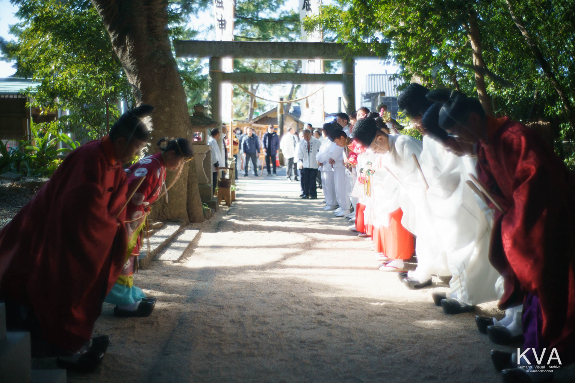 参道脇で拝礼を行う宮司と神職