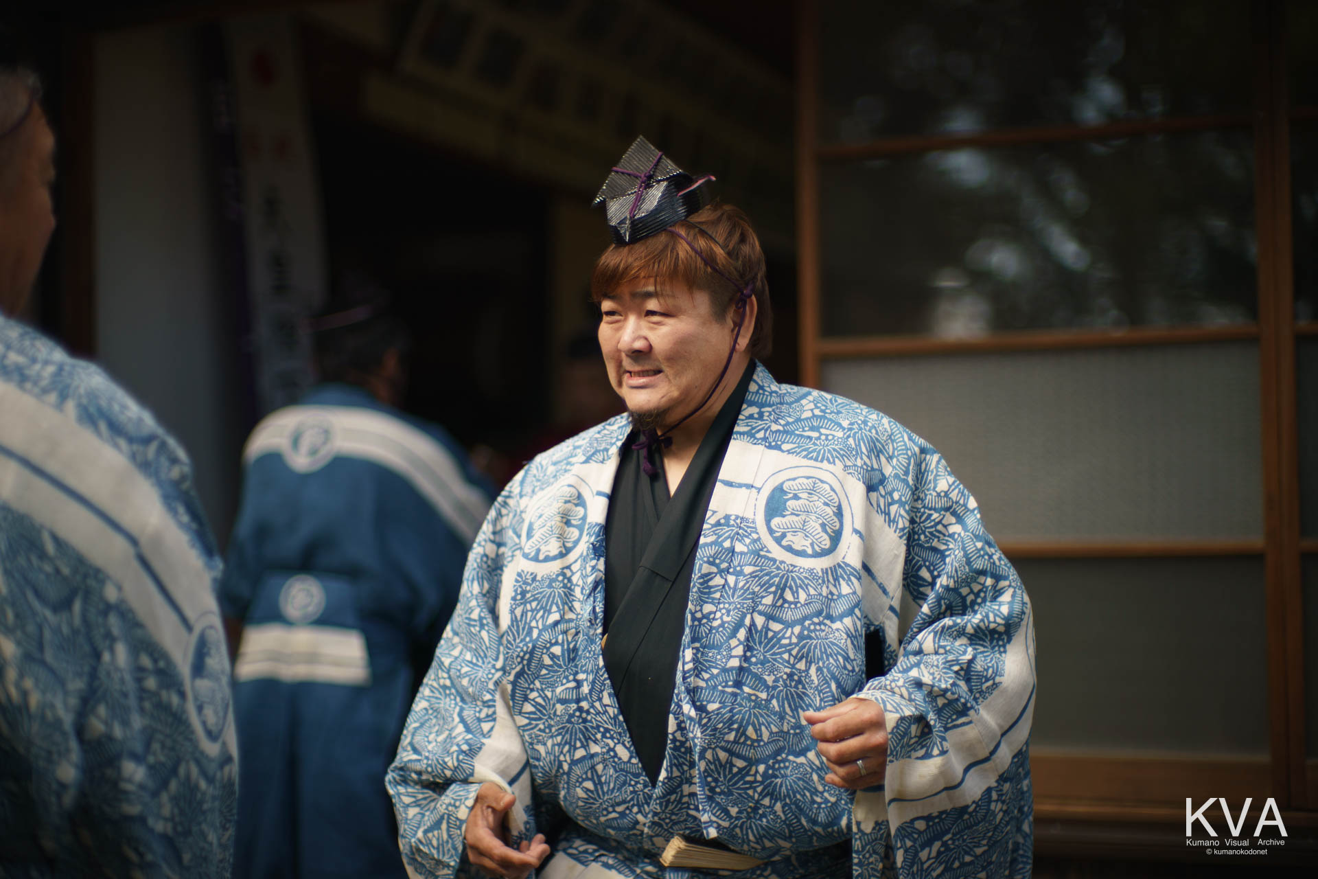 神酒を授かり伝統装束姿で笑顔を浮かべる射手
