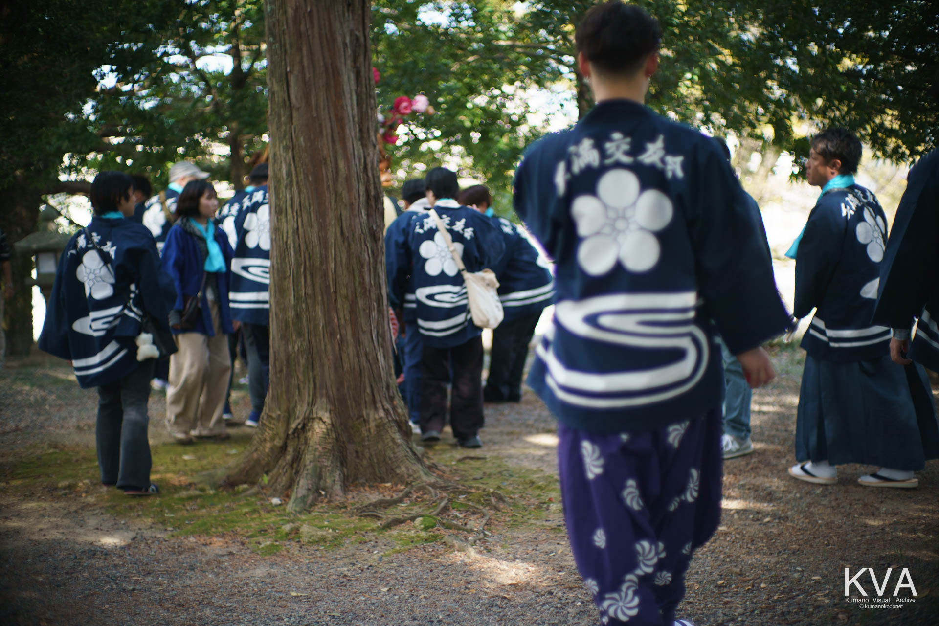 天満交友会の揃いの法被を纏った男たちの後ろ姿